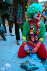 Sunday, December 16th 2007: one of the clown cleaners sitting on the ground. Close to her lays an ice cream on the ground. 